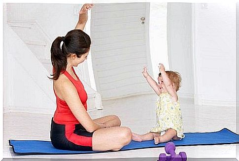 A mother and her baby practicing an asana