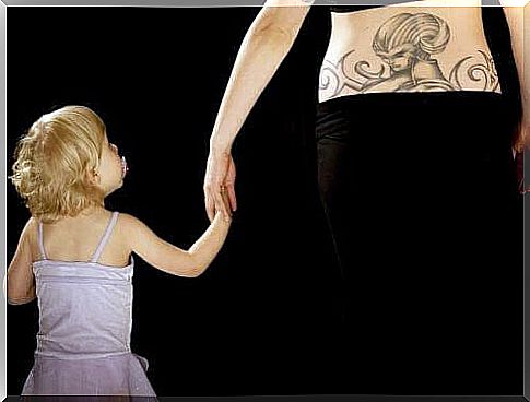 child and mother with tattoo on arm