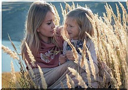 A mother with her daughter in a field