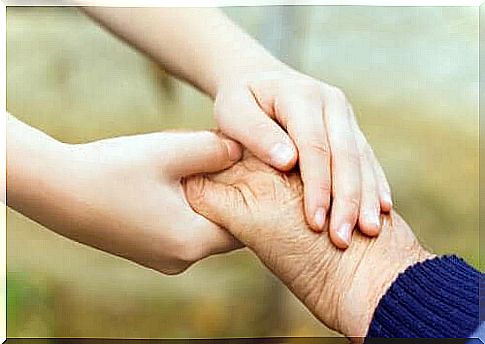 Child and grandparent hold hands