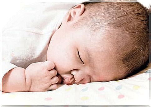 A baby sleeping with his mouth open.