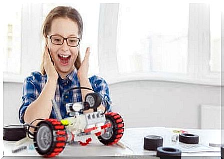 A young girl who has just built a robot. 