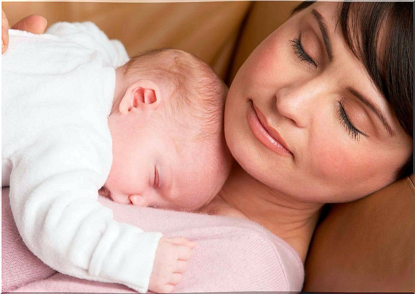 Baby sleeping on his mom