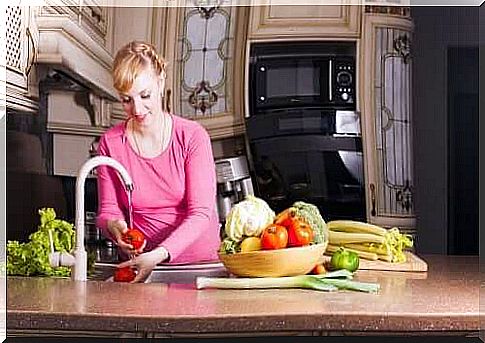 pregnant woman washing vegetables