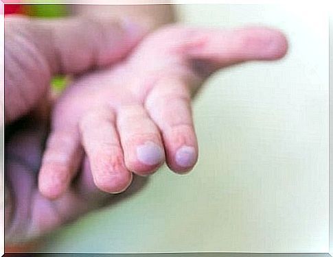 A child's hand with light bulbs. 