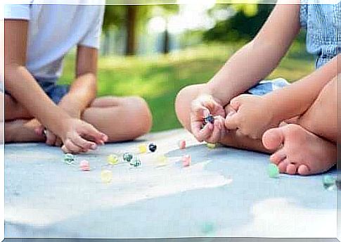 Children play marbles