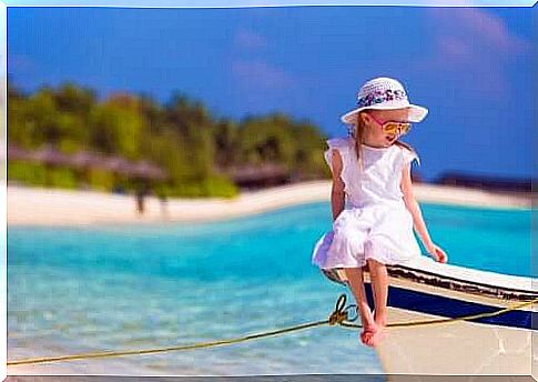 A little girl sitting on a boat