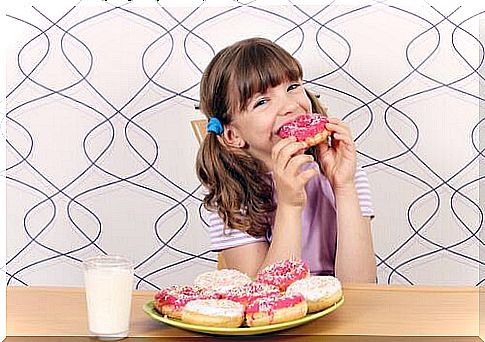 A girl eats donuts