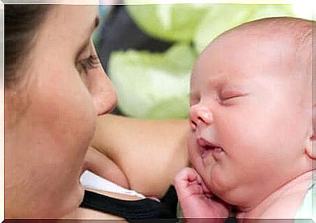 a newborn baby in the arms of his mother. 