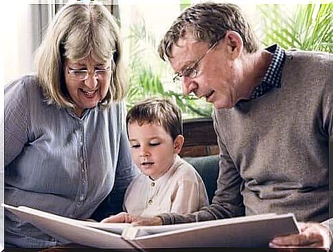 grandparents reading a story to their grandson