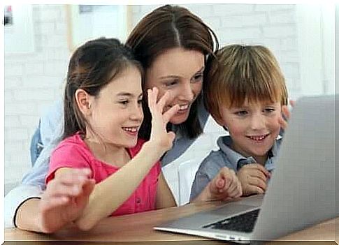 woman and her children in front of a computer